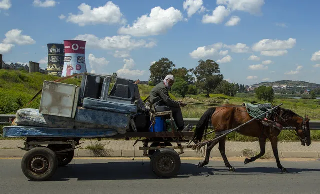 A horse-drawn cart transports old goods in Soweto, South Africa, Thursday, March 19, 2020. As more African countries closed their borders, the coronavirus' local spread threatened to turn the continent of 1.3 billion people into an alarming new front for the pandemic. (Photo by Themba Hadebe/AP Photo)