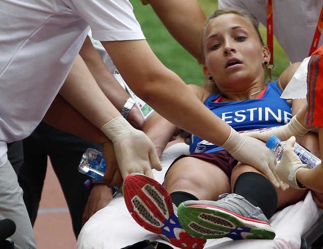Mayada Al-Sayed of the Palestinian Territories receives medical assistance after finishing the women's marathon at the 15th IAAF Championships in Beijing, China August 30, 2015. (Photo by David Gray/Reuters)