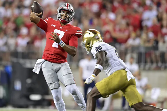 Ohio State quarterback C.J. Stroud throws while being pressured by Notre Dame safety DJ Brown during the second quarter of an NCAA college football game Saturday, September 3, 2022, in Columbus, Ohio. (Photo by David Dermer/AP Photo)