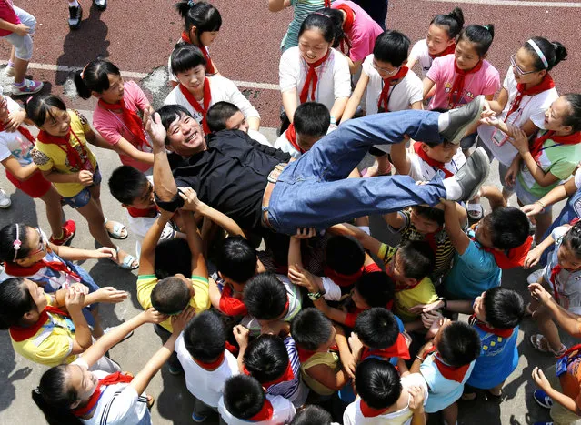 Students upcast their teacher to show their love to teacher the day before Teachers' Day on September 9, 2015 in Zhuji, Zhejiang Province of China. Teachers' Day will kick off in September 10 each year and students do greetings to teachers. (Photo by ChinaFotoPress/ChinaFotoPress via Getty Images)