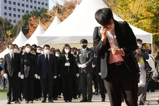 A mourner wipes his tear as he pays a silent tribute for victims of a deadly accident following Saturday night's Halloween festivities, at a joint memorial altar for victims at Seoul Square in Seoul, South Korea, Monday, October 31, 2022. (Photo by Ahn Young-joon/AP Photo)