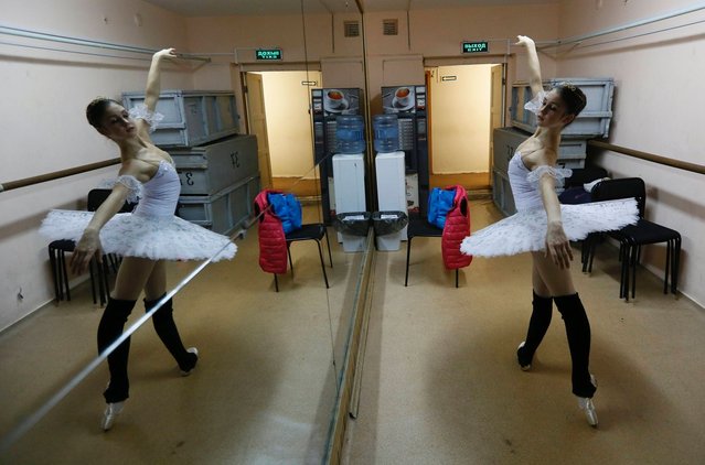 A contestant prepares backstage before her performance during the “Grand Prix of Siberia” international ballet competition, held as part of the 3rd International Forum “Ballet of the XXI Century”, at the State Opera and Ballet Theatre in Krasnoyarsk, on October 9, 2014. (Photo by Ilya Naymushin/Reuters)