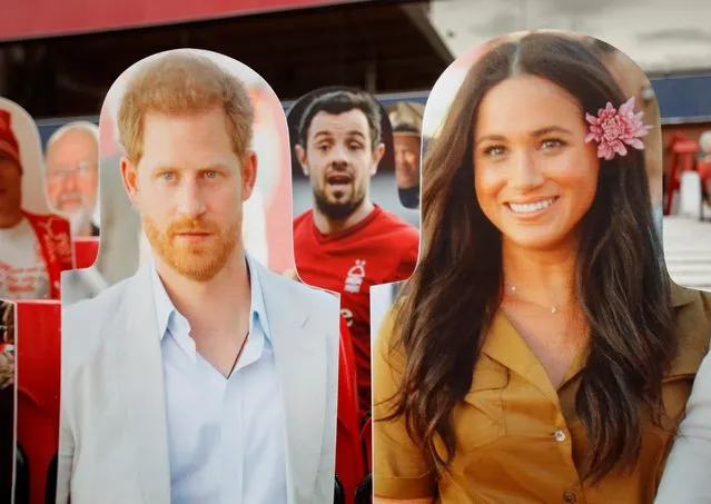 A cut out fan photograph of Prince Harry and Meghan Markle in between former Nottingham Forest player Andy Reid, as play Nottingham Forest v Swansea City resumes behind closed doors following the outbreak of the coronavirus disease (COVID-19) in Nottingham, Britain on July 15, 2020. (Photo by Andrew Boyers/Action Images via Reuters)