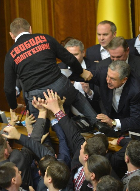 Deputies of the opposition fight with deputies of majority party during the opening of the newly elected Ukrainian parliament in Kiev on December 12, 2012. Ukraine's parliament has seen several physical confrontations in recent years amid bitter confrontation between opposition and pro-government camps. (Photo by Sergei Supinsky/AFP)