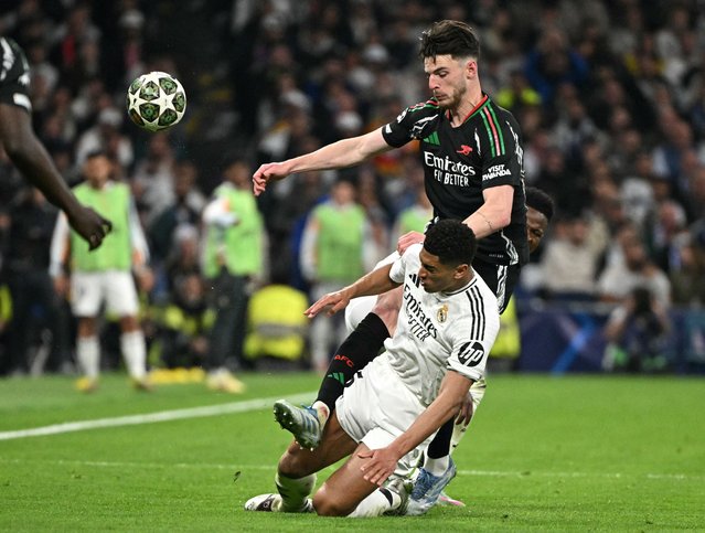 Arsenal's English midfielder #41 Declan Rice fights for the ball with Real Madrid's English midfielder #05 Jude Bellingham during the UEFA Champions League quarter final second leg football match between Real Madrid CF and Arsenal at Santiago Bernabeu Stadium in Madrid on April 16, 2025. (Photo by Javier Soriano/AFP Photo)
