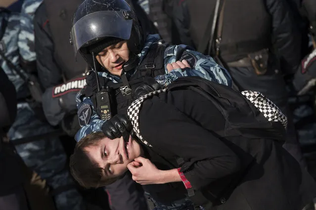 Police detain a protester in Moscow on March 26, 2017. Thousands of people crowded into Moscow's Pushkin Square for an unsanctioned protest against the Russian government, the biggest gathering in a wave of nationwide protests that were the most extensive show of defiance in years. (Photo by Alexander Zemlianichenko/AP Photo)