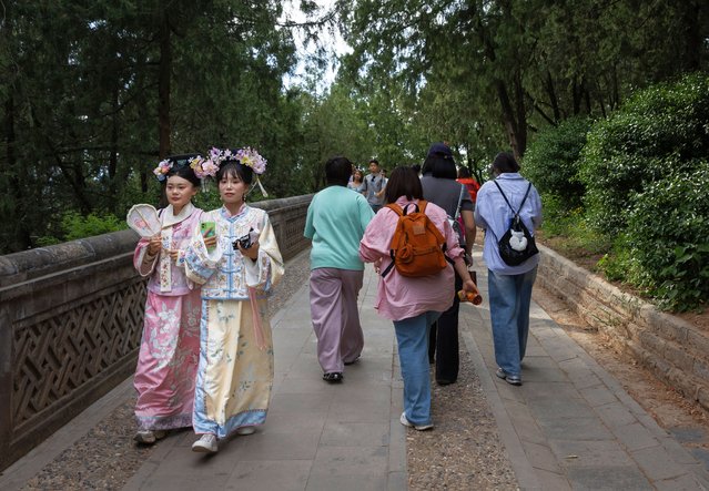 Tourists dressed in Hanfu visit the Summer Palace in Beijing, China, 01 May 2025. International Workers' Day is celebrated annually on 01 May, marking a public holiday in China. (Photo by Jessica Lee/EPA/EFE)