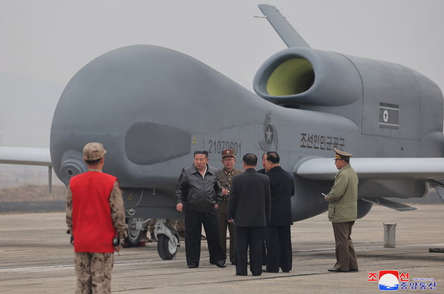 An undated photo released by the official North Korean Central News Agency (KCNA) on 27 March 2025 shows North Korean leader Kim Jong Un (2-L) inspecting what appears to be a large reconnaissance drone at an undisclosed location in North Korea. According to state media KCNA, Kim reviewed newly developed reconnaissance and suicide drones by the Unmanned Aeronautical Technology Complex and an electronic warfare research group, and oversaw their performance test on 25-26 March 2025. (Photo by EPA/EFE)