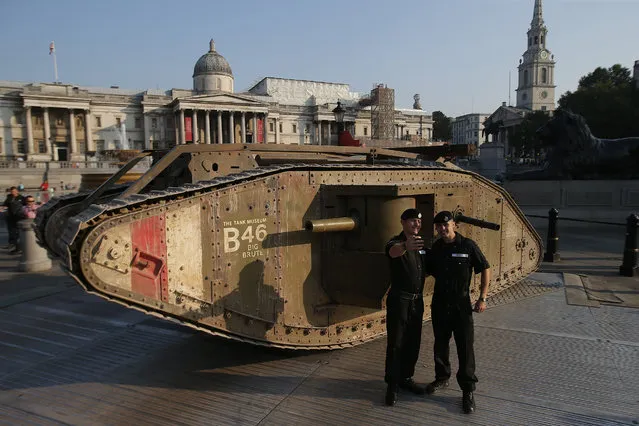 Members of the Royal Tank Regiment stand in front of a replica First World War Mark IV tank in London's Trafalgar Square on September 15, 2016, marking the centenary of an armoured vehicle's first-ever deployment during the Battle of the Somme. (Photo by Daniel Leal-Olivas/PA Wire via ZUMA Press)