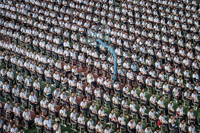 Students attend the 100th anniversary of the founding of Wuhan High School on the first day of the new semester in Wuhan in China's central Hubei province on September 1, 2020. (Photo by AFP Photo/China Stringer Network)