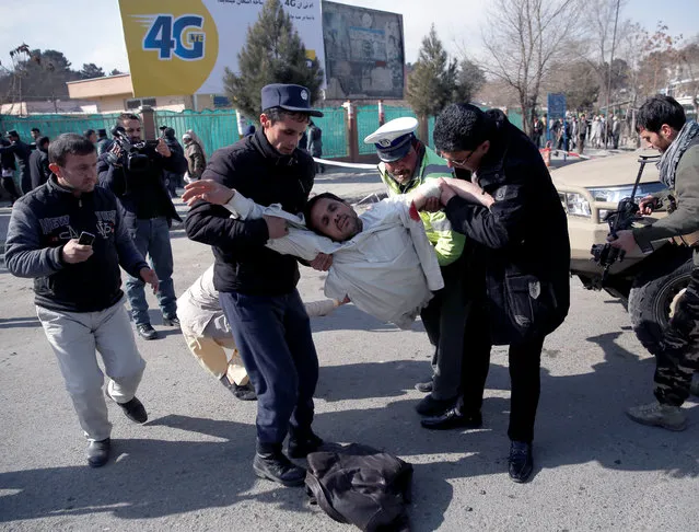 People carry an injured man after a blast in Kabul, Afghanistan, January 27, 2018. The Interior Ministry says a suicide car bomb attack in Kabul leaves dozens wounded. (Photo by Mohammad Ismail/Reuters)