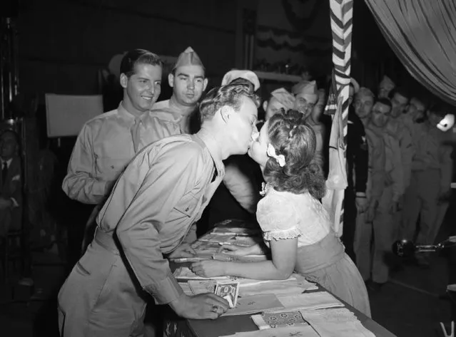 For the first time in her long movie career, Shirley Temple gets kissed in grown-up fashion by Jerry Shane, an ex-Marine from Grand Rapids, Mich., who plays a bit part in the movie called “Kiss and Tell”, January 19, 1945.  Some observers at the historical occasion suspected that Shirley's performance was backed by a little previous necking experience, but Shirley wouldn't admit it. (Photo by Ira W. Guldner/AP Photo)