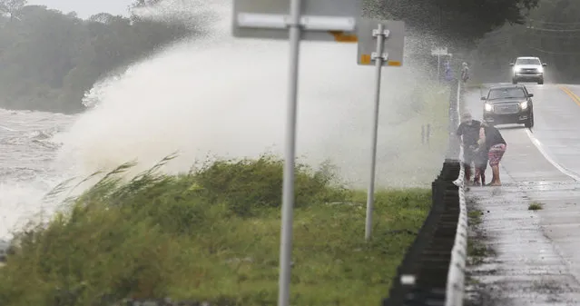 Waves crash over a seawall onto Florida State Highway 20 near Choctaw Beach, Fla., as gusty winds and heavy rains from Hurricane Sally continued to pound the Panhandle area Wednesday, September 16, 2020. (Photo by Michael Snyder/Northwest Florida Daily News via AP Photo)