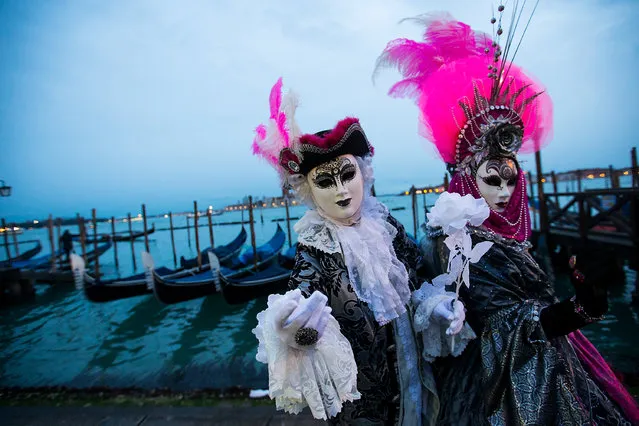 Revelers pose during the Venice Carnival in Venice, Italy, on February 3, 2018. (Photo by Jin Yu/Xinhua/Barcroft Images)