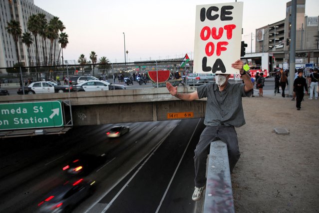 A protester encourages cars on the 101 Freeway to honk their horns during a demonstration in downtown Los Angeles organized by immigrant rights, labor, and grassroots groups to protest federal immigration enforcement actions in Los Angeles, California on August 13, 2025. (Photo by Daniel Cole/Reuters)