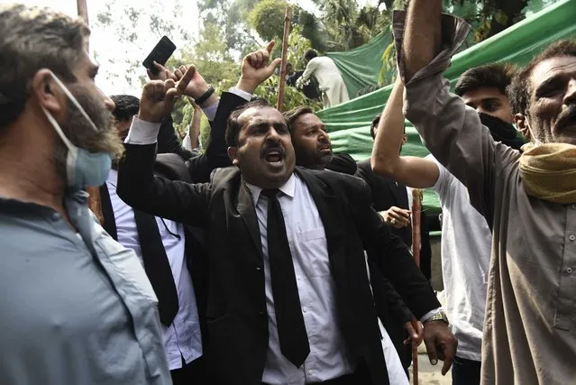 Pakistani lawyers arrive the residence of former Pakistani Prime Minister Imran Khan and Chairman of Pakistan Tehreek-e-Insaf (PTI) to show their solidarity with Khan and PTI in Lahore, Pakistan, on March 15, 2023. There have been clashes between the security forces and the PTI supporters since Tuesday as their leader remained holed up in his Zaman Park residence, defying attempts to arrest him. Local media said at least 54 policemen and eight citizens have bee0n injured in the clashes while the law enforcement agencies have arrested some PTI workers. (Photo by Khurram Amin/Anadolu Agency via Getty Images)