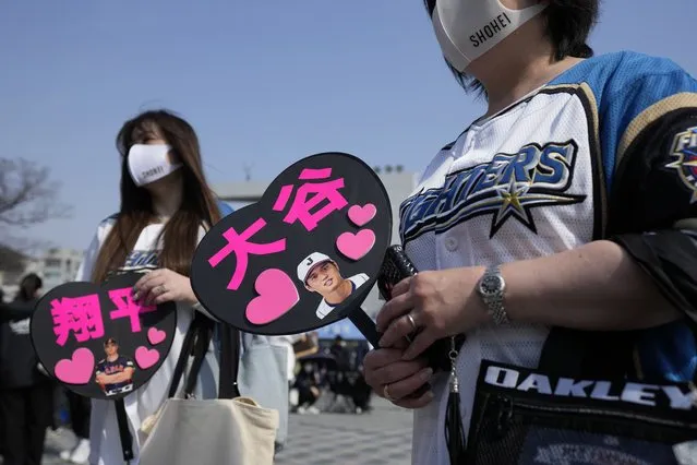 Fans of Japan's Shohei Ohtani cheer prior to the Pool B game between Japan and China at the World Baseball Classic (WBC) at the Tokyo Dome Thursday, March 9, 2023, in Tokyo. The paper fans read in Japanese “Ohtani”," right, and “Shohei”. (Photo by Eugene Hoshiko/AP Photo)