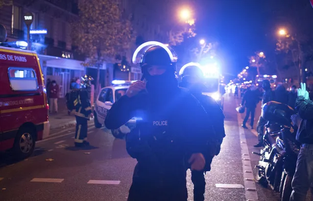 Elite police officers arrive outside the Bataclan theater  in Paris, France, Wednesday, November 13, 2015. (Photo by Kamil Zihnioglu/AP Photo)