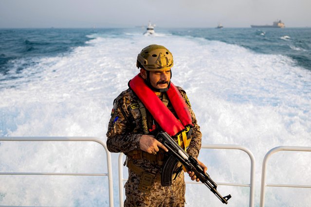 An Iraqi navy marine stands guard while on duty aboard a vessel at sea in the Gulf south of the Faw peninsula on August 5, 2025. (Photo by Hussein Faleh/AFP Photo)