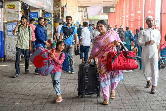 A family is seen leaving to go back home to celebrate the Eid-ul-Fitr festival with their families and friends at the Mohakhali bus terminal in Dhaka, Bangladesh on April 19, 2023. People are returning to their hometowns ahead of Eid-ul-Fitr amid an unrelenting heatwave. Ignoring the scorching hot temperatures, people board trains and buses in a rush to travel home. (Photo by Piyas Biswas/SOPA Images/Rex Features/Shutterstock)