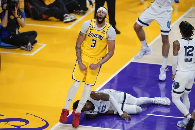 Los Angeles Lakers' Anthony Davis (3) celebrates his dunk as Memphis Grizzlies' Jaren Jackson Jr. (13) falls to the court during the second half in Game 6 of a first-round NBA basketball playoff series Friday, April 28, 2023, in Los Angeles. (Photo by Jae C. Hong/AP Photo)