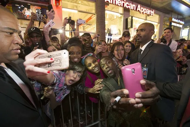 Cast member Kevin Hart takes a selfie with fans at the premiere of the “The Wedding Ringer” at TCL Chinese theatre in Hollywood, California January 6, 2015. The movie opens in the U.S. on January 16. (Photo by Mario Anzuoni/Reuters)