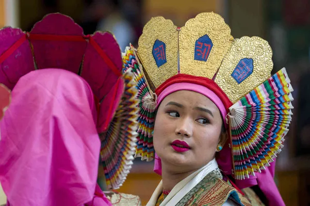 An exile Tibetan artist in traditional costume waits with others to perform in front of her spiritual leader the Dalai Lama at the Tsuglakhang temple in Dharamshala, India, Friday, May 5, 2023. The Tibetan leader attended the 25th anniversary celebrations of the Bharat Tibet Sahyog Manch. (Photo by Ashwini Bhatia/AP Photo)