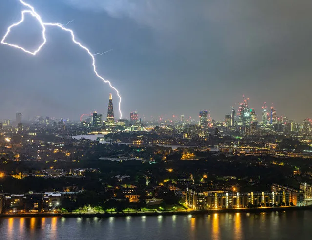A bolt of lightning lights up the sky above the Shard in  London, Britain on May 26, 2018. After a sunny start to the bank holiday weekend, with temperatures reaching 27C (80.6F), a thunderstorm broke out accompanied by heavy rain. (Photo by Matt Cooper/SWNS.com)