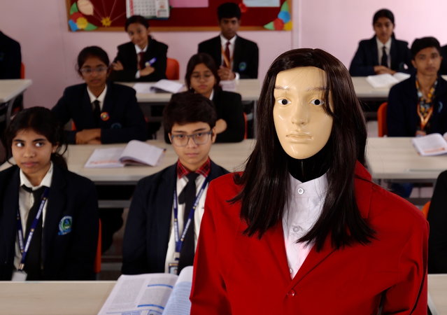 Students attend interactive classes with 'IRIS', an Artificial Intelligence driven robotic class teacher, at De Sales Academy in Bangalore, India, 27 November 2025. Iris is India's first Generative Artificial Intelligence (AI) educator, developed in collaboration with Makerlabs Edutech. Equipped with voice assistance, it responds to student queries, offers explanations, and delivers educational content through personalized interactive learning activities. (Photo by Jagadeesh N.V./EPA)