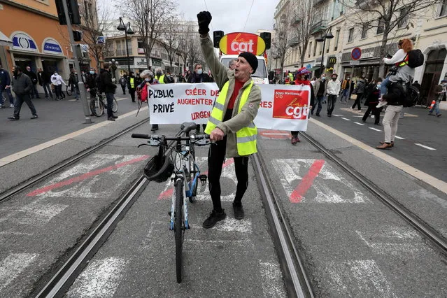 A protestor wearing a yellow vest walks with his bike during a demonstration by French CGT labour union members in Nice as part of a national day of strikes and protests against layoffs and government's economic and social policies amid the coronavirus disease (COVID-19) outbreak in France, February 4, 2021. (Photo by Eric Gaillard/Reuters)
