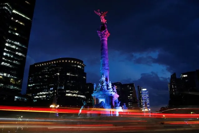The monument of the Angel of Independence is seen illuminated with colored lights in support of the International Day Against Homophobia, Transphobia, and Biphobia, in Mexico City, Mexico on May 17, 2023. (Photo by Raquel Cunha/Reuters)