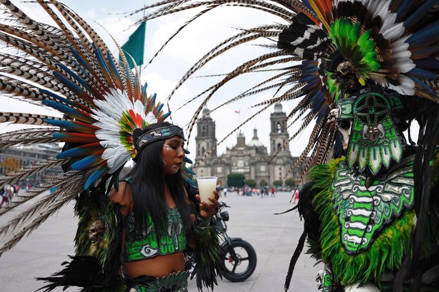 A dancing woman drinks “pulque” (a pre-Hispanic beverage) during a peaceful protest in the Zócalo of Mexico City, Mexico, 04 September 2024. Producers handed out glasses of pulque and demonstrated to demand that the Ministry of Culture recognize this drink and its producers as part of Mexico City's cultural heritage. (Photo by Sáshenka Gutiérrez/EPA/EFE)