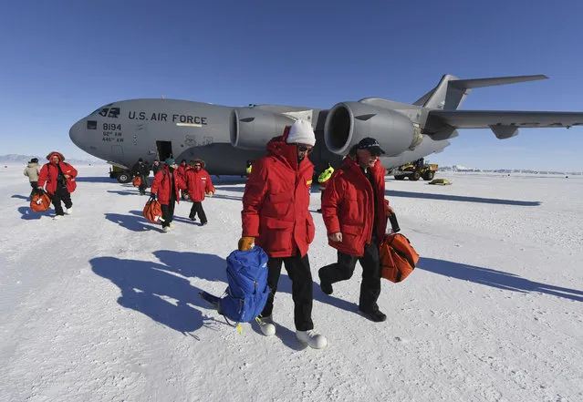 US Secretary of State John Kerry, center, disembarks from a U.S. Air Force C17 Globemaster with National Science Foundation's Scott Borg, right, at the Pegasus ice runway near McMurdo Station, Antarctica, Friday,  November 11, 2016. (Photo by Mark Ralston/Pool Photo via AP Photo)