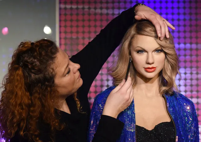 A worker at Madame Tussauds puts the finishing touches to a new wax figure of singer Taylor Swift on December 18, 2015 in Berlin, Germany. (Photo by  Jens Kalaene/DPA/Corbis)