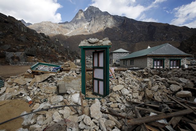 A door of a collapsed house stands after the earthquake damaged it earlier this year at Khumjung, a typical Sherpa village in Solukhumbu district also known as the Everest region, in this picture taken November 30, 2015. (Photo by Navesh Chitrakar/Reuters)