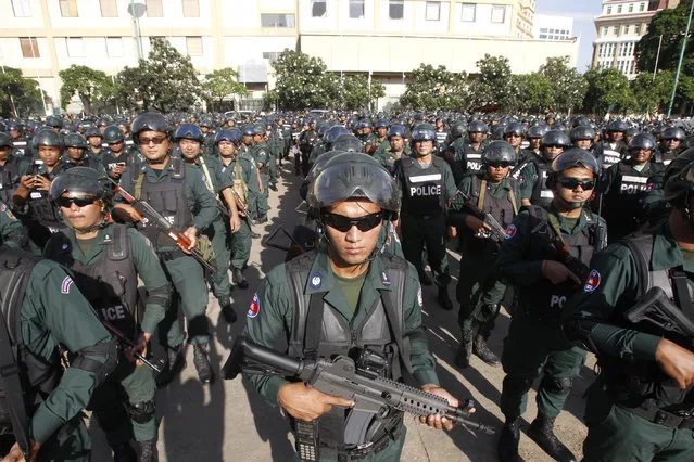 Cambodian riot police officers stand in lines before being sent to polling stations for securities in Phnom Penh, Cambodia, Wednesday, July 25, 2018. Cambodia's general elections were scheduled for July 29. (Photo by Heng Sinith/AP Photo)