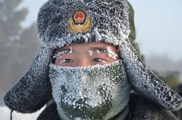 Icicles form on the eyebrows and eyelashes of a paramilitary police officer taking part in cold weather training in Inner Mongolia Autonomous Region, China on January 22, 2016. (Photo by Imaginechina/Rex Features/Shutterstock)