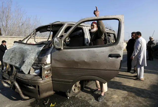An Afghan man stands next to his damaged vehicle after a suicide attack in Kabul, Afghanistan, December 28, 2015. (Photo by Mohammad Ismail/Reuters)