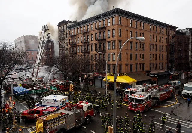 Firefighters work to extinguish a fire in a building that collapsed in New York City, March 26, 2015. (Photo by Justin Lane/EPA)