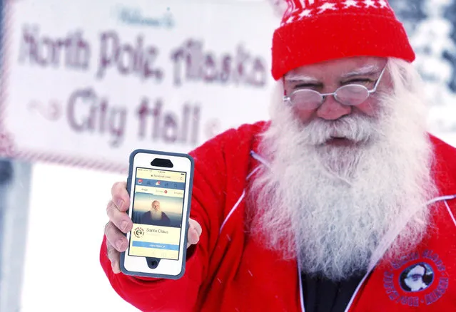 In this Wednesday, December 28, 2016 photo, Santa Claus displays his now-functioning Facebook page outside North Pole City Hall in North Pole, Alaska. Santa Claus' Facebook account has been reinstated after the social media company suspended his access and demanded proof of identity on Christmas Day. Claus, a North Pole city councilman, said he was never given a reason why his page was blocked. A Facebook spokeswoman apologized in an email Tuesday, Dec. 27, for suspending Claus' account and said it was done by mistake. (Photo by Eric Engman/Fairbanks Daily News-Miner via AP Photo)