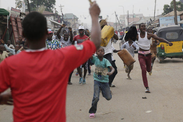 Residents celebrate the anticipated victory of Presidential candidate Muhammadu Buhari  in Kaduna,  Nigeria Tuesday, March 31, 2015. (Photo by Jerome Delay/AP Photo)