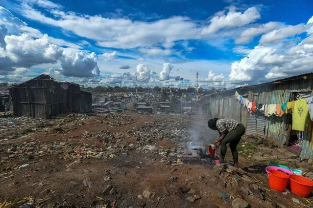 Residents of Mathare slum work on the processes of coal production in hard conditions in the capital of Kenya, Nairobi on November 06, 2023. The coal that workers produce with primitive methods by working overtime in unlicensed workshops is used for heating, cooking and other daily needs. (Photo by Gerald Anderson/Anadolu via Getty Images)