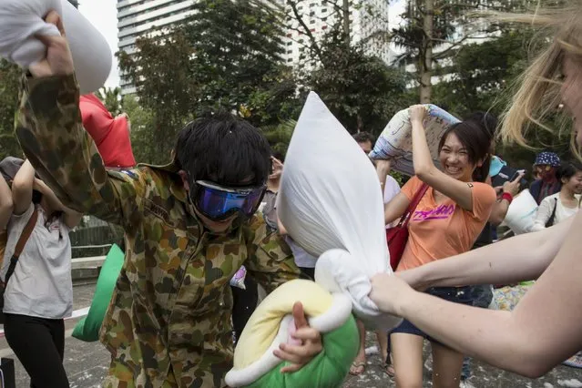 People take part in the International Pillow Fight Day at Hong Kong's financial Central district April 4, 2015. (Photo by Tyrone Siu/Reuters)