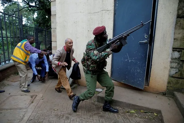 A member of security forces keeps guard as people are evacuated at the scene where explosions and gunshots were heard at the Dusit hotel compound, in Nairobi, Kenya January 15, 2019. (Photo by Thomas Mukoya/Reuters)