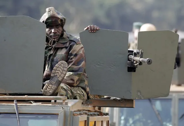 An Ugandan soldier sits on top of an armoured vehicle in Kampala, Uganda February 20, 2016. (Photo by Goran Tomasevic/Reuters)