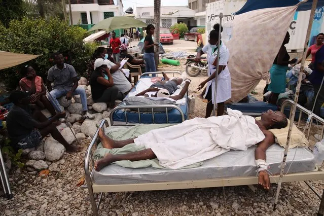 Some of the injured during the earthquake are assisted in the surroundings of the general hospital due to the lack of available beds in Les Cayes, Haiti, 16 August 2021, two days after the 7.2 magnitude earthquake. Tropical depression Grace is expected to cross the Dominican Republic and Haiti, after 14 August the country suffered a 7.2 magnitude earthquake that has left more than 700 dead, as Fred resurfaced in the Gulf of Mexico as a tropical storm. (Photo by Orlando Barria/EPA/EFE/Rex Features/Shutterstock)