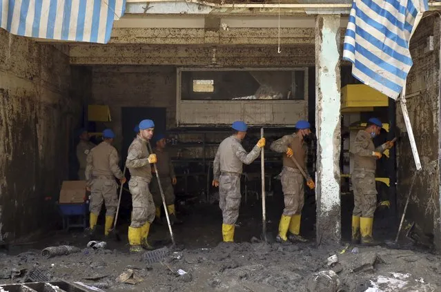 Soldiers clear the mud from a shop in Bozkurt town of Kastamonu province, Turkey, Saturday, August 14, 2021. The death toll from severe floods and mudslides in coastal Turkey has climbed to at least 44, the country's emergency and disaster agency said Saturday. Torrential rains that pounded the Black Sea provinces of Bartin, Kastamonu and Sinop on Wednesday caused flooding that demolished homes, severed at least five bridges, swept away cars and rendered numerous roads unpassable. (Photo by AP Photo/Stringer)