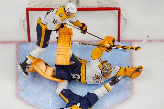 Nashville Predators goaltender Juuse Saros (74) dives for a glove save during the game between the Detroit Red Wings and the Nashville Predators at Little Caesars Arena in Detroit, Michigan on December 29, 2023. (Photo by Brian Bradshaw Sevald/USA TODAY Sports)