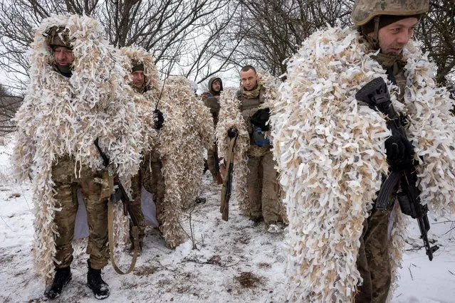 Ukrainian servicemen of the 93rd separate mechanized brigade wear ghillie suits during training near the front line in the Donetsk region, amid Russia’s attack on Ukraine, on December 25, 2023. (Photo by Thomas Peter/Reuters)