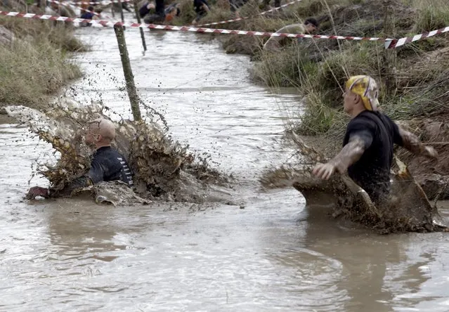 Participants compete during the Strong Race event near Tukums, Latvia May 3, 2015. (Photo by Ints Kalnins/Reuters)